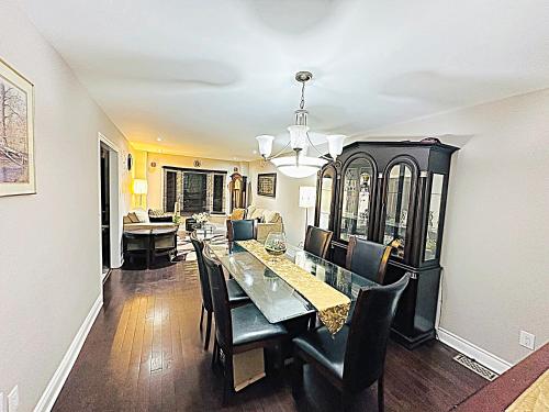 a dining room with a table and chairs at Beautiful House in Mississauga in Mississauga