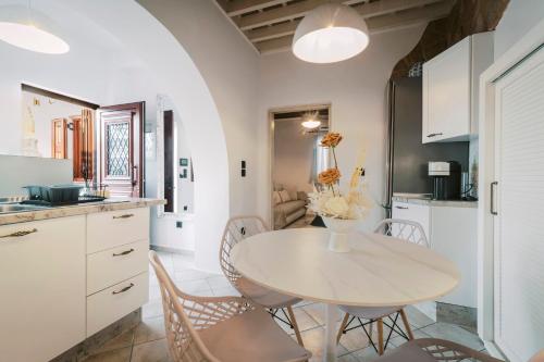 a kitchen and dining room with a table and chairs at Lindos Zen luxury villa in Líndos
