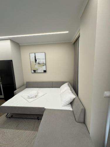a small bedroom with a bed in a room at Azure Apartments in Korçë