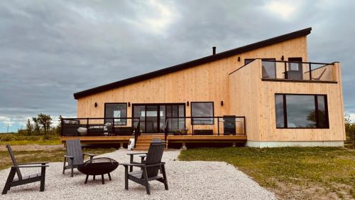 a large house with chairs and a patio at Ten Mile Point Resort in Little Current
