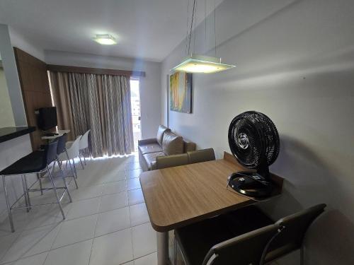 a living room with a table with a fan on it at Apartamentos em Rio Quente com maravilhosa área de lazer e excelente localização in Rio Quente