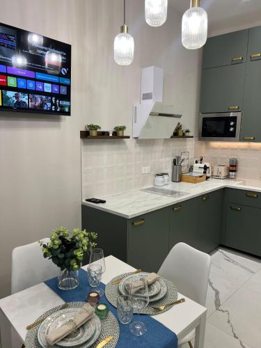 a kitchen with a table and chairs and a counter at Pearl of Nice in Nice
