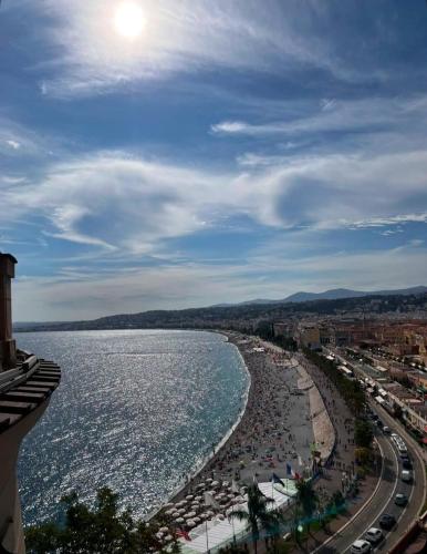 a view of a beach with crowds of people at Pearl of Nice in Nice