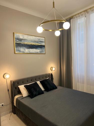 a bedroom with a bed with two lights on it at Pearl of Nice in Nice