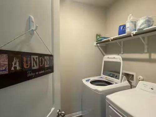 a laundry room with a washing machine in it at Perfect getaway/Easy access to downtown! - Nile in Manor