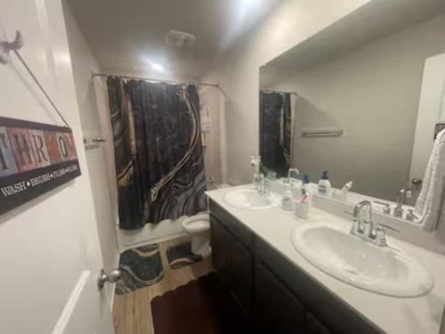 a bathroom with two sinks and a mirror at Perfect getaway/Easy access to downtown! - Nile in Manor