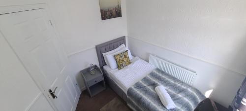 a small room with a bench with a pillow at Starlet Single Room in Manchester
