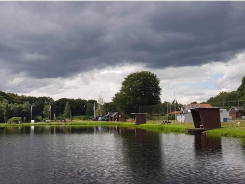 a body of water with houses and a cloudy sky at 5 person holiday home in Hovborg-By Traum in Hovborg