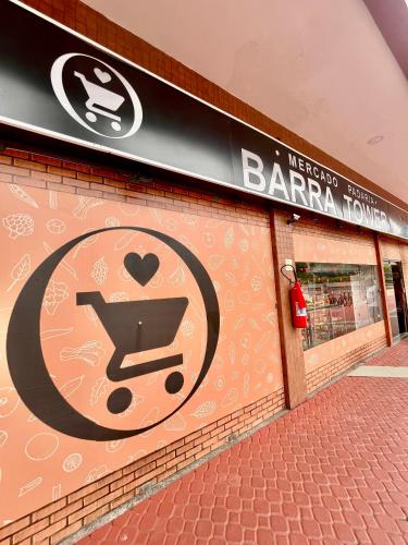 a sign on the side of a store with a shopping cart at Flat na Barra da Tijuca-G 1408-4 in Rio de Janeiro