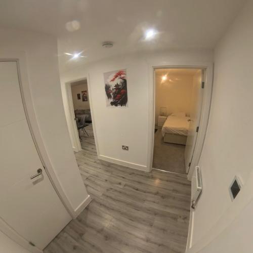 a hallway with a room with a bed and a mirror at Luxurious Apartment Birmingham in Birmingham