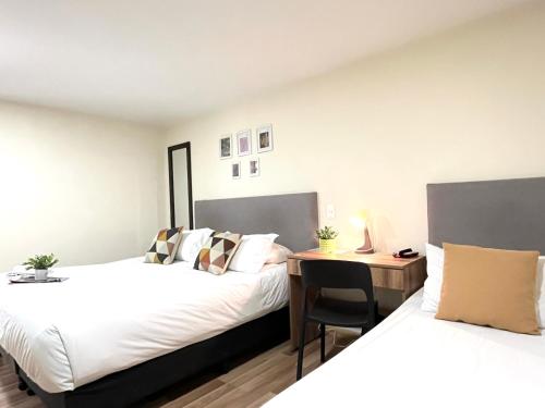 Ein Bett oder Betten in einem Zimmer der Unterkunft Terraza Hotel Bogota