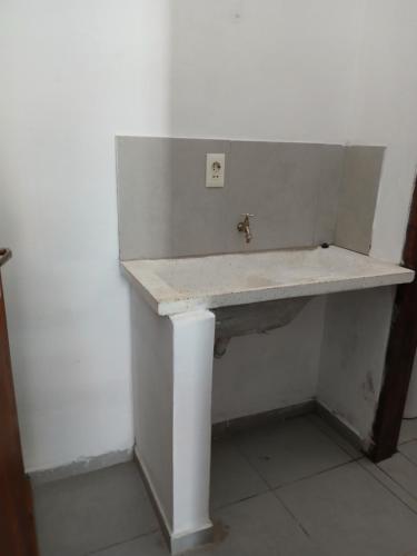 a sink in a room with a white wall at Residencial Lapacho in Luque