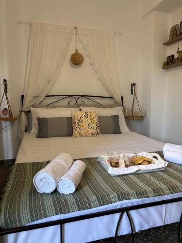 a bed with a tray of food on top of it at Villa Marika in Ierápetra