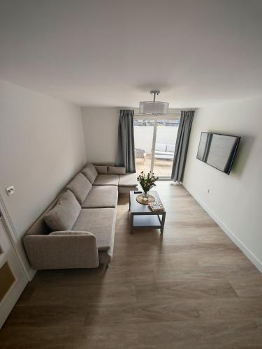 a living room with a couch and a table at Cozy corner 2 bedroom house in Edinburgh
