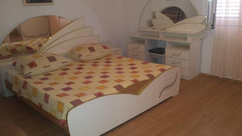a toy bedroom with a bed and a dressing room at Apartments Igor in Bibinje