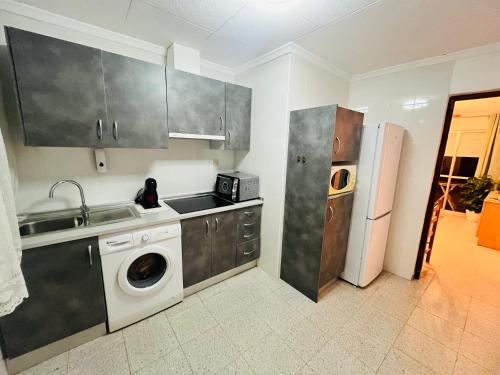 a kitchen with a sink and a washing machine at Sun & Salt Lo Pagan in San Pedro del Pinatar
