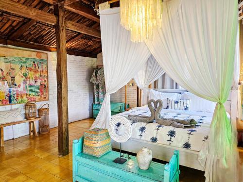 a bedroom with a bed with a canopy at Janur Bungalow in Borobudur