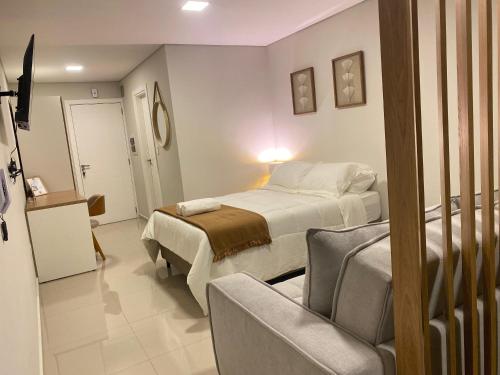 a bedroom with a bed and a chair in it at Bello y confortable Apartamento con Parking in Encarnación