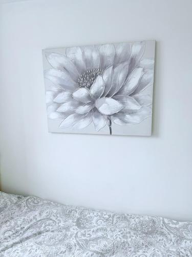 a black and white picture of a flower on a wall at White Rose Double Bed Apartment in Bradford