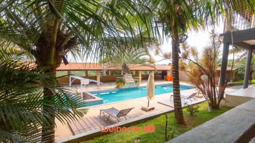 an overhead view of a swimming pool with palm trees at Casa ampla em Mairinque com lazer completo in Mairinque