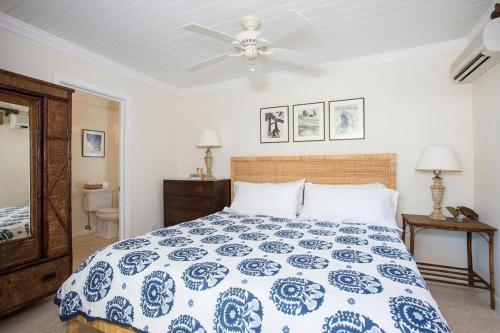 a bedroom with a bed and a ceiling fan at Buccaneer Hill Main House home in Governorʼs Harbour