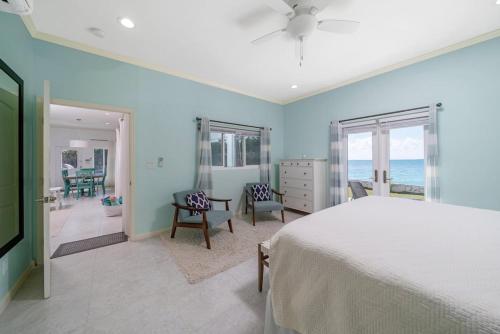 a bedroom with a bed and a view of the ocean at Bella Mer home in Savannah Sound