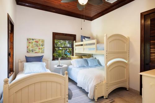 a bedroom with two beds and a bunk bed at Coconut Point home in Palmetto Point