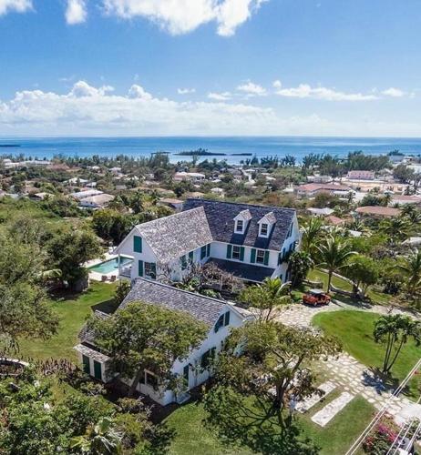 an aerial view of a house with the ocean at Buccaneer Hill Cottage cottage in Governorʼs Harbour