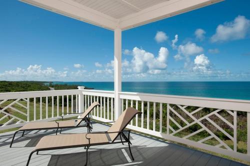 a porch with chairs and a view of the ocean at Buttonwood Reserve Two Entire Building Duplex in James Cistern