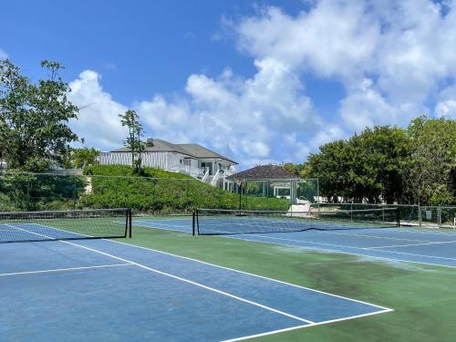 a tennis court with two tennis courts at Sunnyside home in Savannah Sound