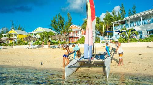 a group of people on a sail boat on the beach at Cocodimama Resort Hotel Room in James Cistern