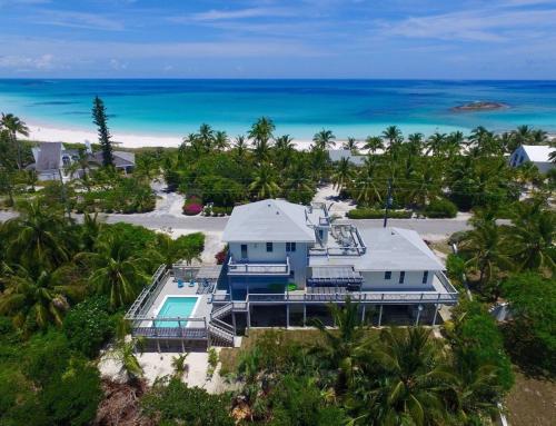 an aerial view of a house on the beach at Salty Dolphin home in Governorʼs Harbour