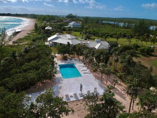 an aerial view of a resort with a swimming pool and the beach at Plage Rose Estate home in South Palmetto Point