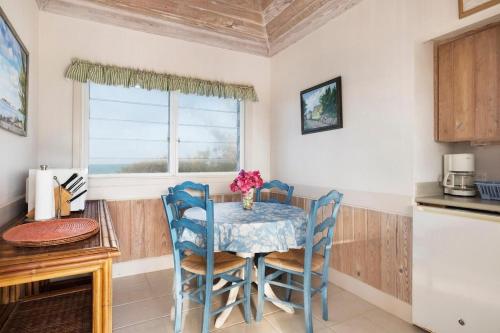a kitchen with a table and chairs and a window at Plage Rose Estate home in South Palmetto Point