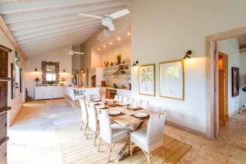 a dining room with a table and chairs at Wild Orchid home in Governorʼs Harbour