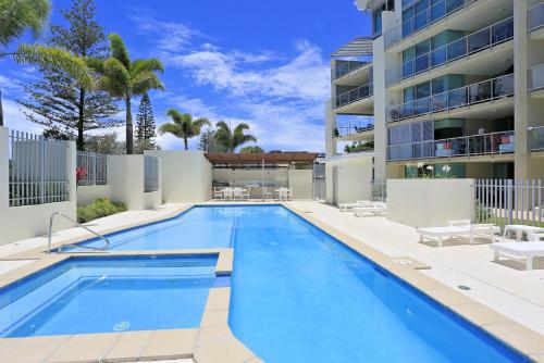 a swimming pool in front of a building at Unit 37 Dwell in Bargara