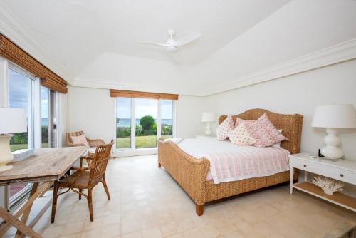 a bedroom with a bed and a table and chairs at Palm Hill House home in Rock Sound