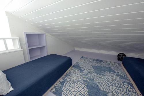 a room with two beds in a room with a bed sidx sidx sidx at Lavender Beach House home in James Cistern