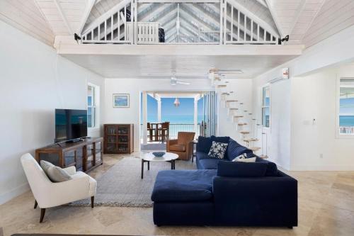 a living room with a blue couch and a tv at Buttonwood Reserve Main Lodge home in James Cistern