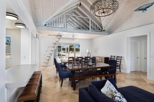 a dining room with a table and chairs and a clock at Buttonwood Reserve Main Lodge home in James Cistern