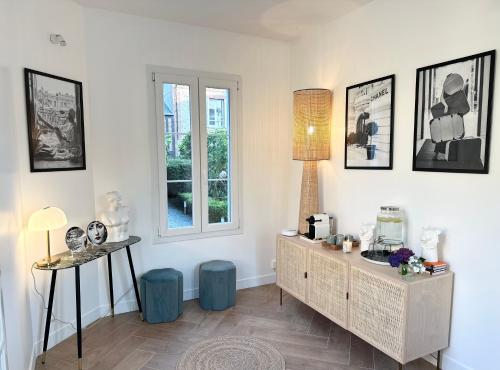 a living room with a dresser and a window at Villa La Renaissance - Etretat in Étretat