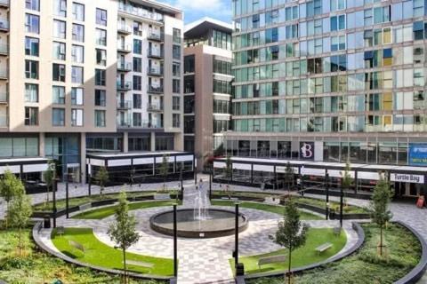 a fountain in the middle of a city with buildings at The urban corner MK in Milton Keynes