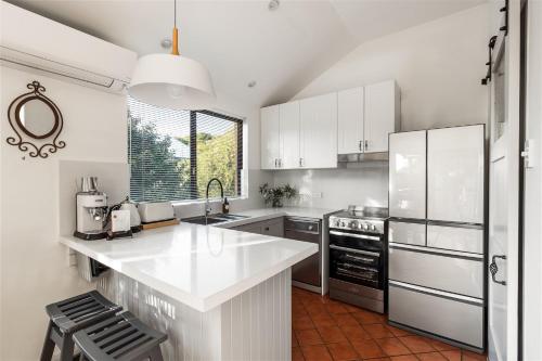 a kitchen with white cabinets and a white counter top at Little Freycinet - NEW in Gnarabup