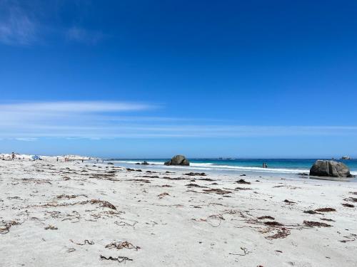 a beach with rocks in the sand and the ocean at Cabaña en Vallenar in Vallenar