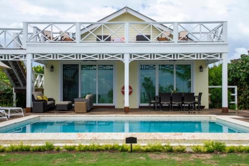 a villa with a swimming pool and a house at Wild Orchid 3 Bedroom home in North Palmetto Point