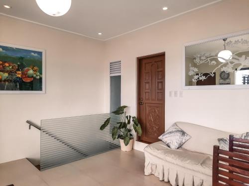 a living room with a couch and a table at Rosal House - Beachfront for 12 Pax in Lemery Batangas 