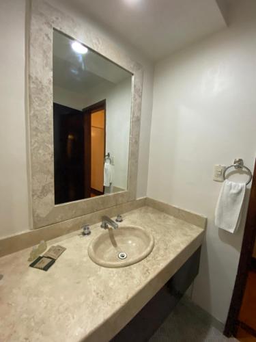 a bathroom with a sink and a mirror at Hacienda de Jalpan in Jalpan