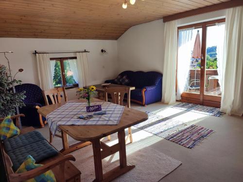 a living room with a table and a couch at Widernhof in Prien am Chiemsee