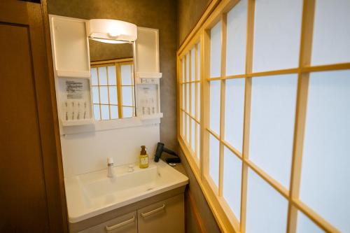 a bathroom with a sink and a mirror at 金柑和屋 in Osaka