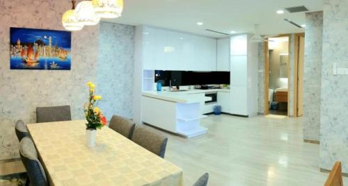 a dining room with a table and a tv in a room at Seaview shared apartment in Johor Bahru